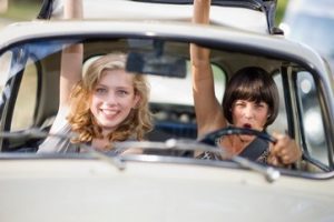 Two young ladies inside the car